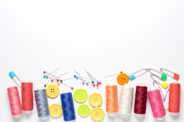 colorful thread spools and needles